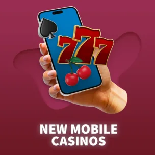 a hand holding a mobile phone with casino related icons one the screen, text below reads new mobile casinos