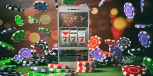 Slot machine on a smartphone screen, poker chips and abstract background.