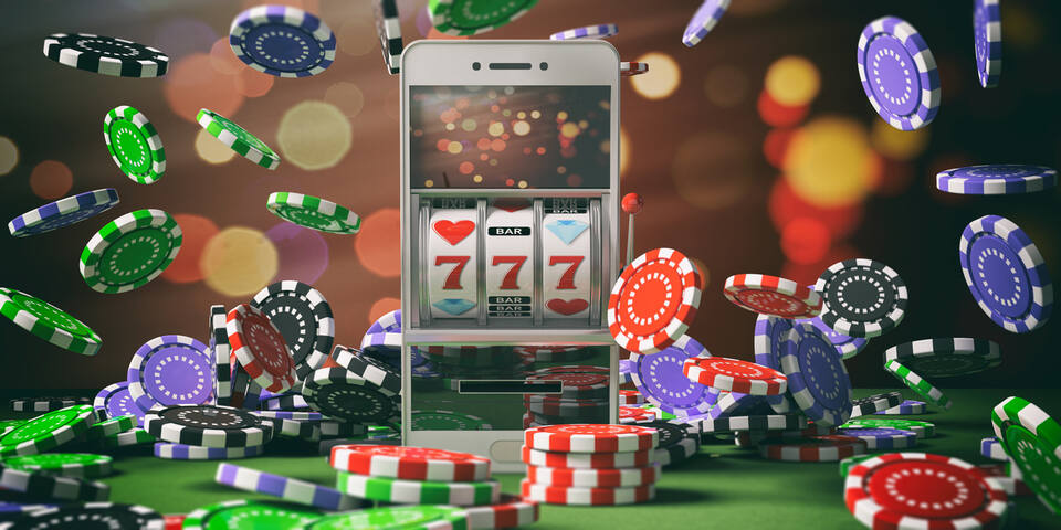 Slot machine on a smartphone screen, poker chips and abstract background.