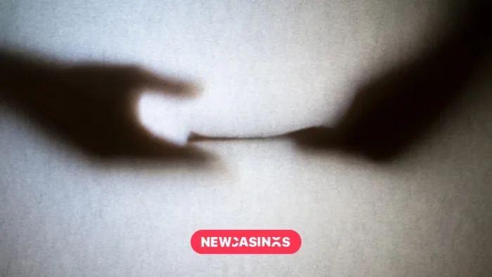 UK Charges Former GVC Leaders Over Alleged Bribes Silhouette of paper being passed from one hand to another.