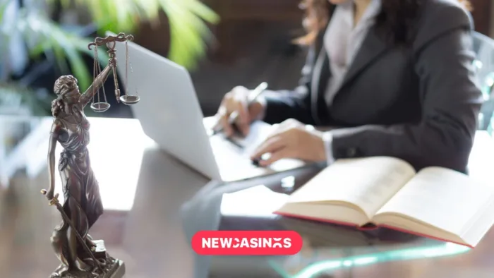 The Rise of Black Market Gambling: Key Takeaways from the UKGC Report Scales of justice in the foreground of a woman working on a laptop with papers.